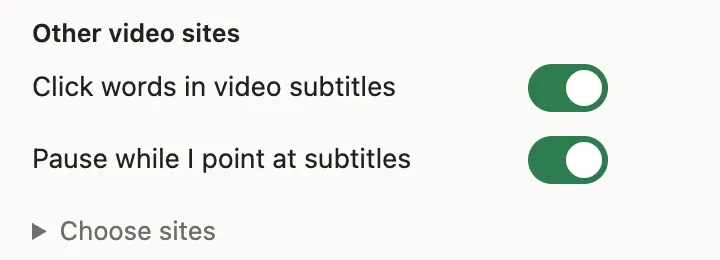 The Videos part of the Lexpad menu, under Other video sites: Click words in video subtitles and Pause while I point at subtitles, both on, and Choose sites