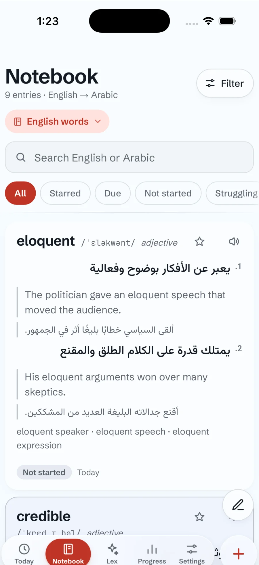 A notebook of English words with Arabic meanings and examples, each side in its own direction